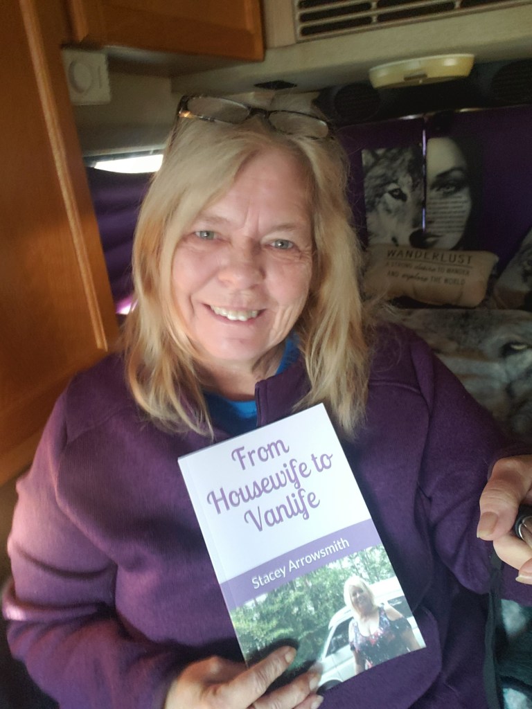Myself with my book From Housewife to Vanlife describing my journey from a sticks and bricks to living an RV Life