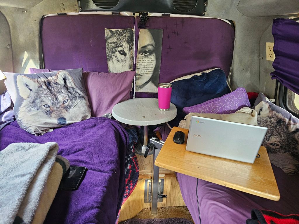My bed, table and couch in my roadtrek
