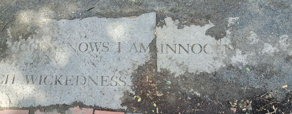 Innocence marked in stone outside the cemetary in Salem