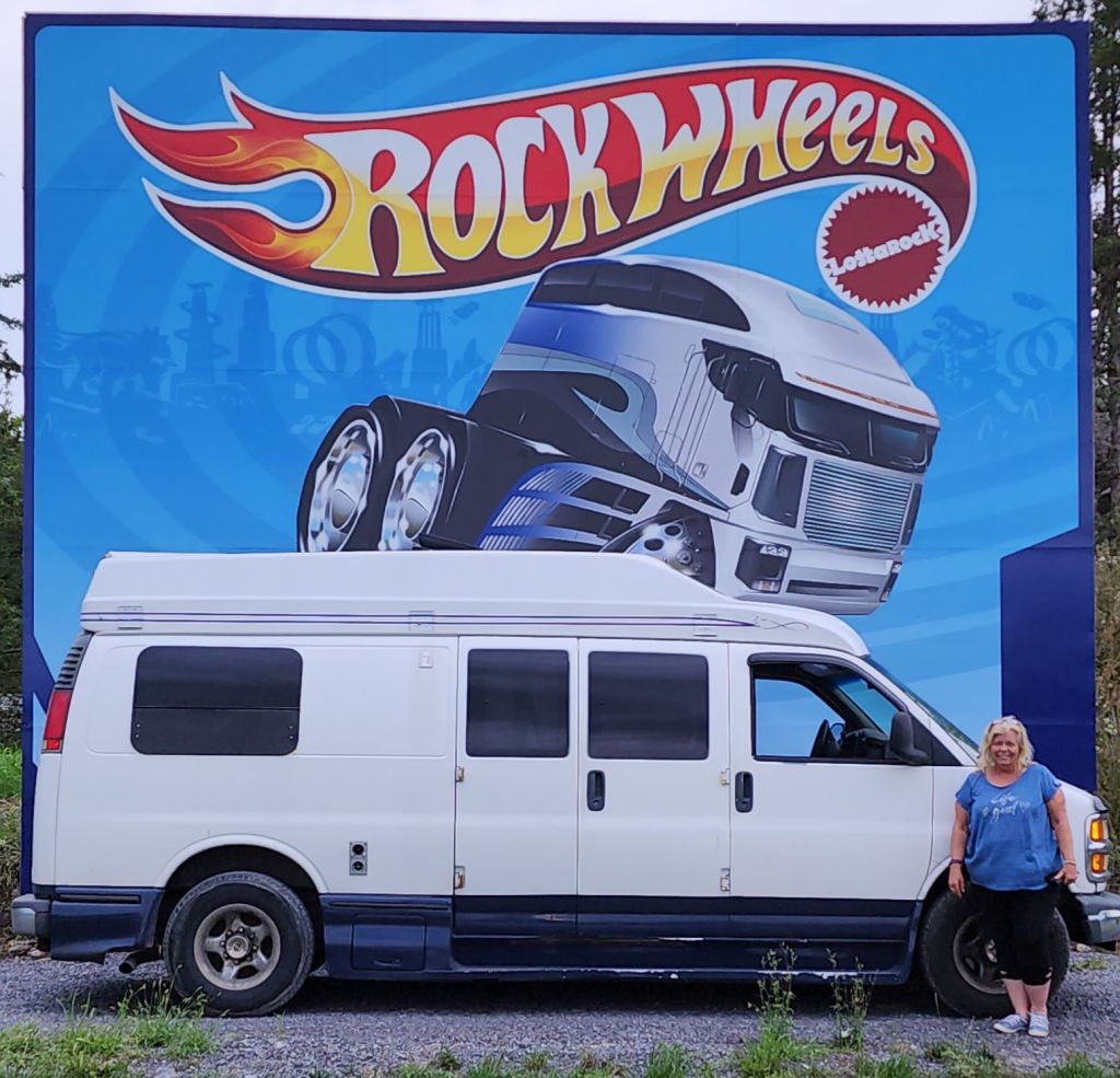 My roadtrek in front of the billboard