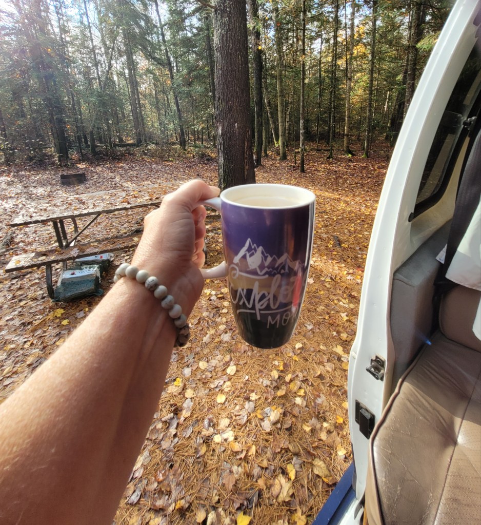 Cheering the fall weather with my coffee mug at a provincial park.